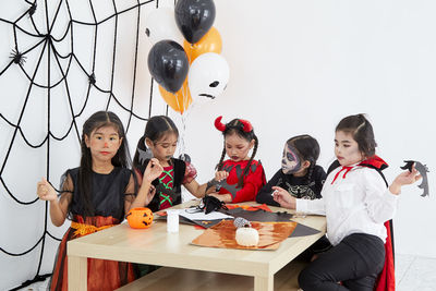 High angle view of people sitting on table