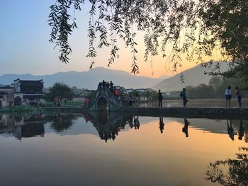 Scenic view of calm lake against clear sky during sunset