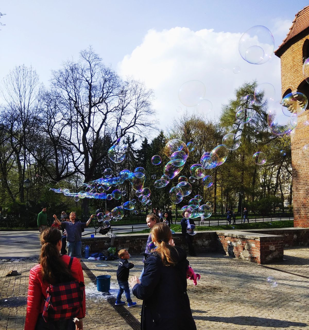 PEOPLE AT PARK AGAINST SKY