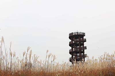 Cross on field against clear sky