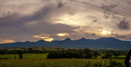 Scenic view of field against sky during sunset