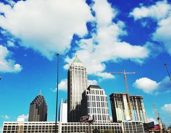 Low angle view of buildings against cloudy sky