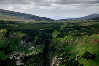 Scenic view of green landscape and mountains