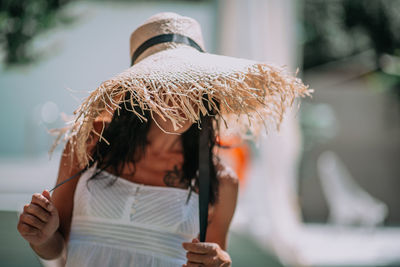 Midsection of woman holding ice cream standing outdoors