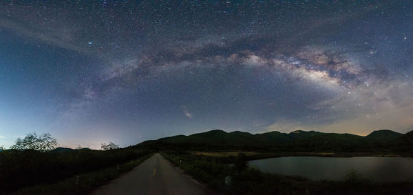 Scenic view of road against sky at night