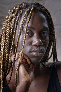 Close-up portrait of serious young woman with braided hair