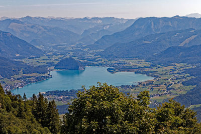 High angle view of sea and mountains against sky