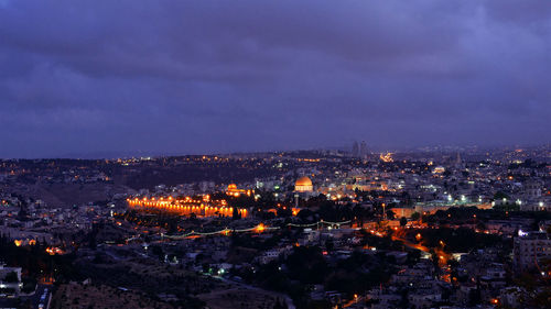 Aerial view of city lit up at night