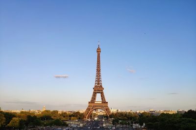 Eiffel tower in city against sky