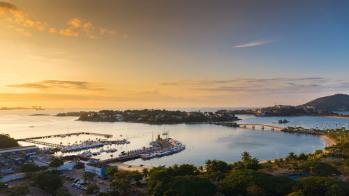 High angle view of bay against sky at sunset