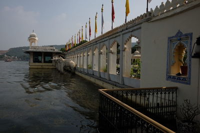 Bridge over canal amidst buildings against sky