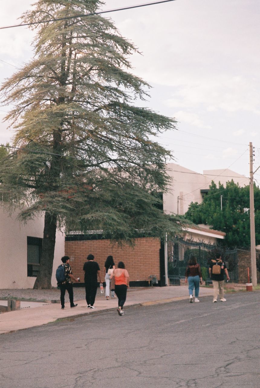 PEOPLE WALKING IN FRONT OF BUILDINGS