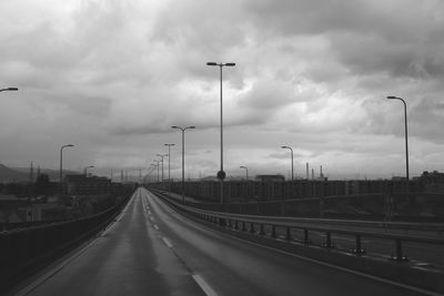Vehicles on highway against sky