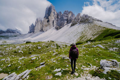 Rear view of person on snowcapped mountains against sky