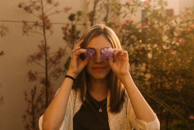 Woman holding flowers as eyes