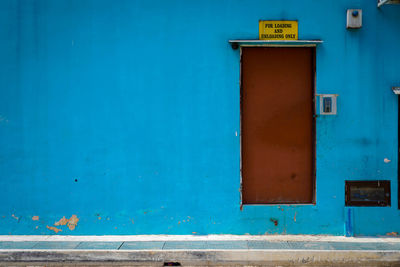 Close-up of blue sign on building wall