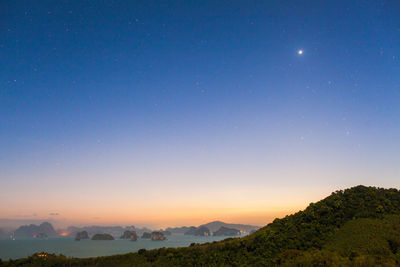 Scenic view of mountains against sky at night