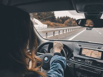 Midsection of woman in car