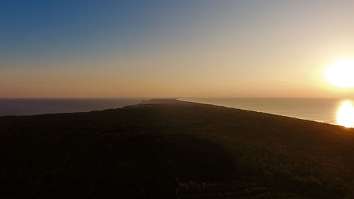 Scenic view of sea against clear sky during sunset