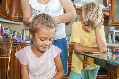 Siblings standing at home