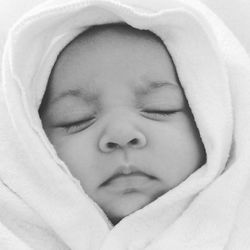 Close-up of baby girl sleeping at home