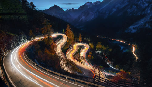 High angle view of light trails on road at night