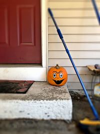 Close-up of pumpkin against door