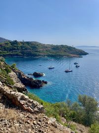 High angle view of sailboats on sea shore against sky