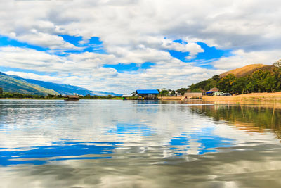 Scenic view of lake against cloudy sky