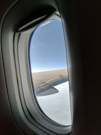 View of airplane wing seen through window