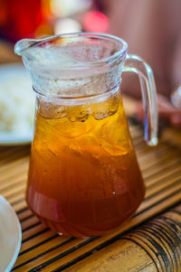 Close-up of lemon tea in jug on table