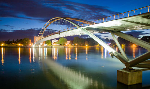 View of bridge over river at night