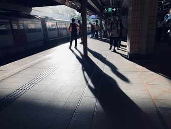 People walking on railroad station platform