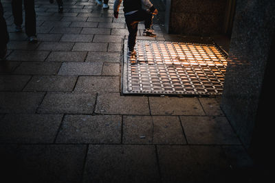 Low section of people walking on footpath