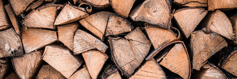 Textured firewood background of chopped wood for kindling and heating the house. a woodpile