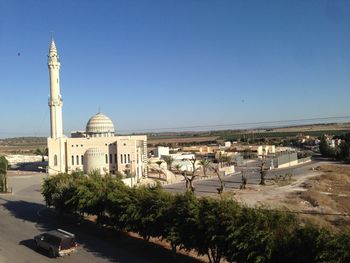 Buildings in city against clear sky