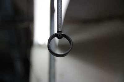 Close-up of electric lamp hanging on metal