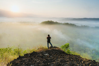 Man standing on mountain against sky