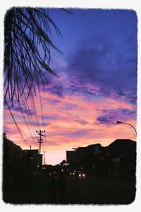 Silhouette city against sky during sunset