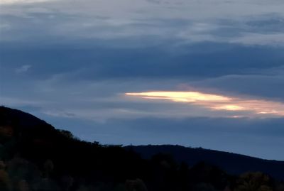 Low angle view of silhouette mountain against sky at sunset