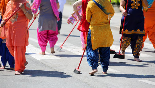 Low section of people walking on road