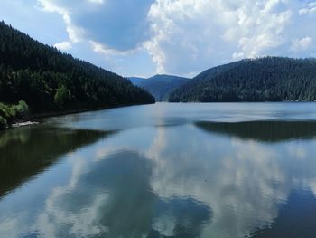 Scenic view of lake and mountains against sky