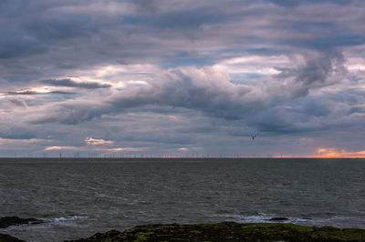 Scenic view of sea against cloudy sky