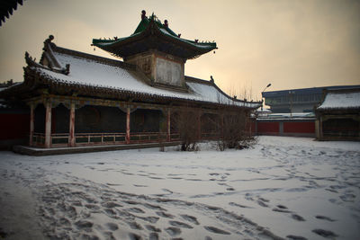 Building against sky during winter