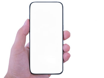 Close-up of hand holding smart phone over white background