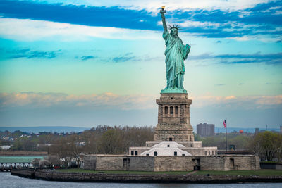 Statue of liberty against cloudy sky
