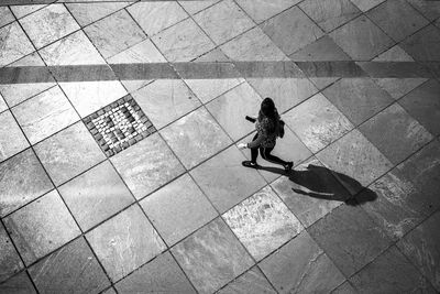 High angle view of woman walking on footpath