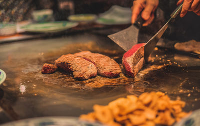 Close-up of person preparing food on table