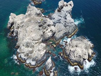 High angle view of rocks in sea