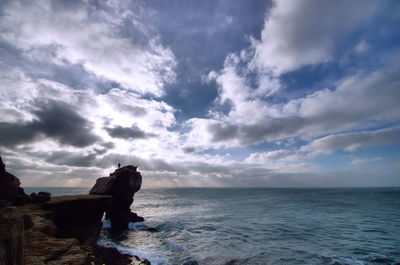 Scenic view of sea against cloudy sky